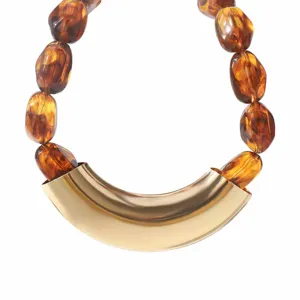 Detailed close-up of vintage tortoiseshell resin bead statement necklace with gold metal tube.