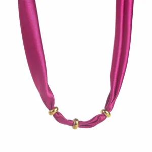 Fabric silk scarf necklace detail view, elegant fuchsia fabric with gold metal rings choker.