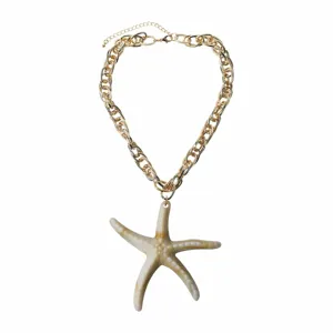 Detailed view of the resin starfish pendant necklace with a chunky gold aluminum chain.