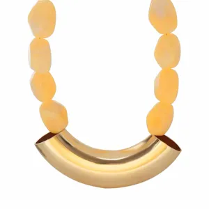 Close-up detail of the vintage geometric resin beaded necklace with a gold curved tube.
