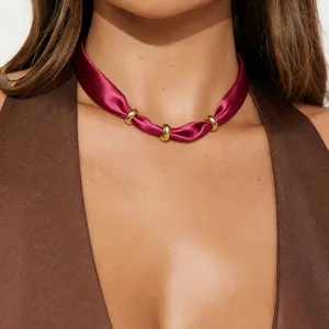 Chic burgundy satin choker necklace with sleek metal rings, elegant minimalist collar jewelry.
