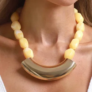 Vintage geometric resin beaded statement necklace with a large curved gold metal pendant.