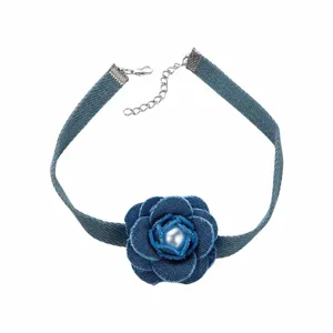 Close-up detail of the denim fabric flower choker necklace with center pearl and chain.