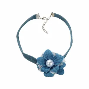 Denim flower choker detail shot featuring delicate lace trim and a central pearl accent.