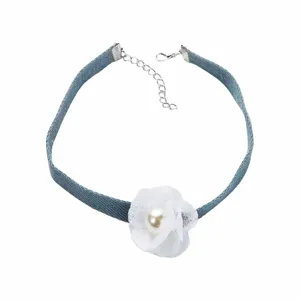 Detailed view of blue denim fabric flower choker necklace with pearl and adjustable chain.
