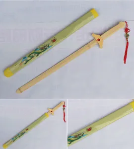 Close-up detail view of wooden toy sword with dragon pattern scabbard and red tassel.