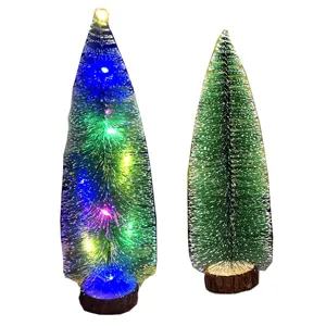 Mini tabletop Christmas tree set with colorful LED lights and wooden base for holiday decor.