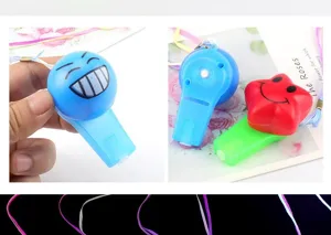 Luminous flashing whistle detail shot, showing glowing components and smiley toy designs.