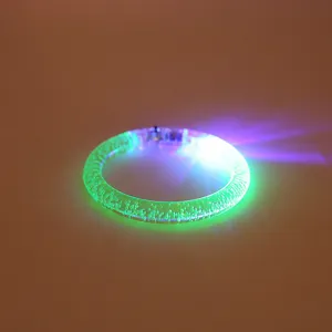 Close-up detail of acrylic LED glowing bracelet with bubble texture for night parties and kids toys.