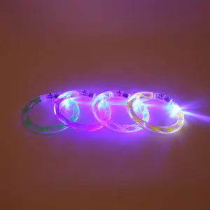 Close-up detail of colorful glowing LED acrylic bracelets with bright lights for night toys.