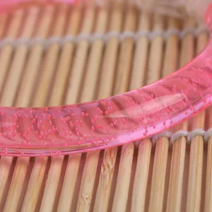 Pink translucent acrylic bubble bracelet detail view, trendy toy wrist accessory for kids.