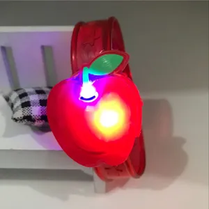 Details of the red apple glowing slap bracelet children toy, close-up view of the LED light.