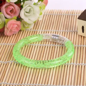 Detailed view of a green acrylic LED glowing bubble bracelet, perfect flashing toy for kids and parties.