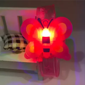 Children glowing LED butterfly silicone wristband toy, flashing night light bracelet detail.