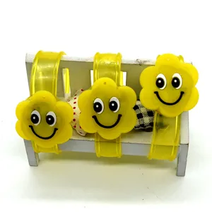 Cute yellow flower silicone slap bracelets glowing LED wristbands children party toys detail view.