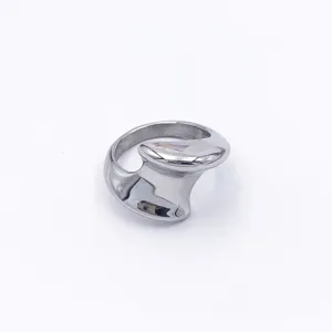 Gedetailleerde close-up van een grove, sculpturale roestvrijstalen ring met modern design.