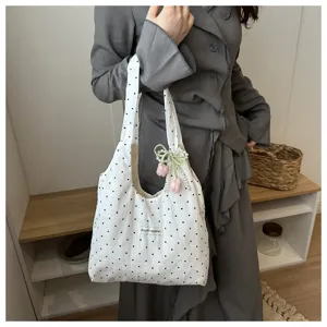 Korean style polka dot canvas tote bag detail view with cute pearl and tulip pendant charm.