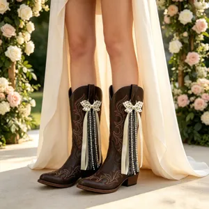 Women brown western cowboy boots with bow ribbon pearl tassel decorations and floral embroidery.