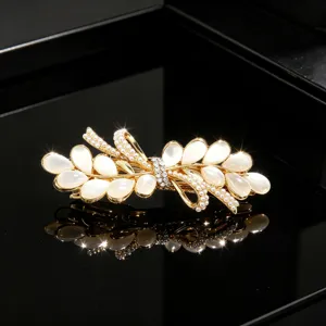Elegant gold opal rhinestone bow hair clip detail view, sparkling crystal barrette for women.