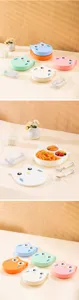 Detailed close-up shot of cute owl style children divided lunch box with matching spoon fork set.