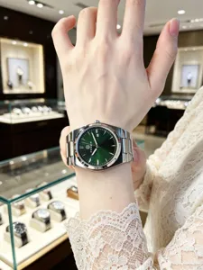 Men's stylish stainless steel green dial quartz watch detailed showcase on wrist fashion.