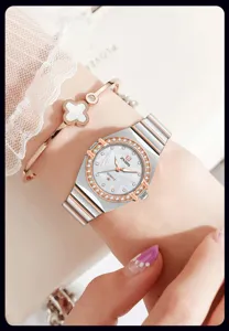 Elegant women quartz watch with pink mother of pearl dial and crystal bezel detail.