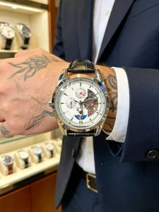 Men mechanical watch detail view, luxury automatic wristwatch with moonphase and leather strap.