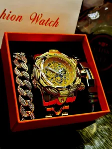 Golden punk style men's watch set with chunky steel strap and matching bracelets in gift box.