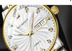 Luxury automatic mechanical watch dial detail, gold bezel, white textured dial with calendar.