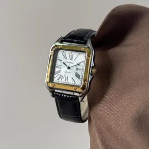 Detaillierte Nahaufnahme einer quadratischen zweifarbigen Armbanduhr mit römischen Ziffern.