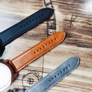 Detailed close-up shot of multi-color leather watch straps with fine stitching and metal case.