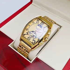 Luxury gold tone tonneau automatic mechanical watch featuring skeleton tourbillon and moon phase.