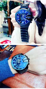 Oversized mens quartz watch with bold blue dial and black metal strap, stylish design detail.