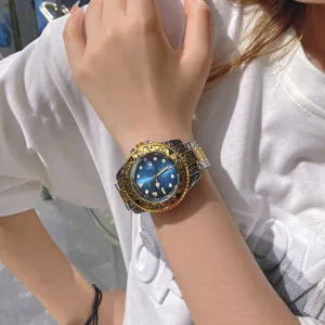 Luxury men's quartz watch with blue gradient dial and gold carved bezel lifestyle shot.