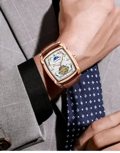 Men's tonneau automatic mechanical watch with brown leather strap and skeleton dial.