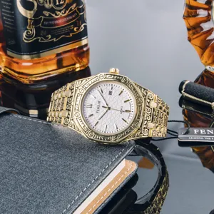 Vintage engraved gold quartz watch for men with steel strap, textured dial and date display.