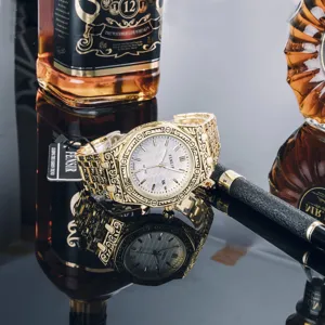 Vintage carved gold quartz watch detailed view, showing textured dial and decorative strap.