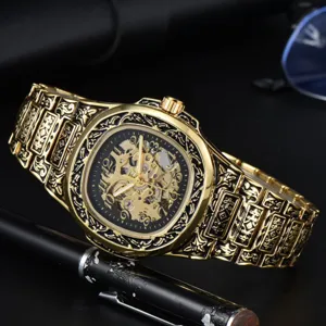 Men retro gold mechanical watch featuring skeleton dial and vintage embossed stainless steel strap.