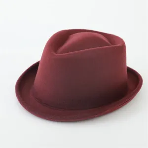 Detail shot of a burgundy felt fedora hat, showing fine texture and vintage style.