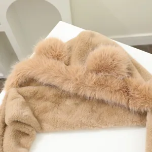 Close-up detail of plush bear ear hooded scarf, soft fluffy khaki winter warm accessory.
