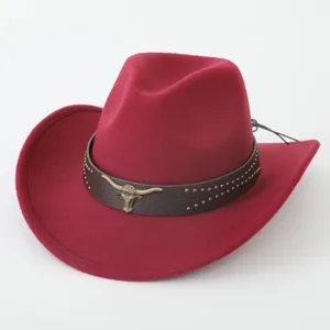 Red western cowboy hat with brown leather band and vintage bull skull for travel.