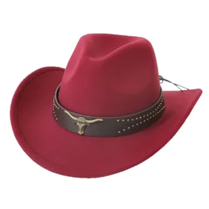 Red western cowboy hat with brown leather band and metal bull head emblem for travel outdoor.