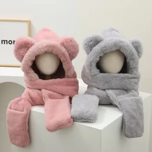 Close-up detail of fluffy bear ear hooded scarf and gloves set in pink and grey for winter warmth.