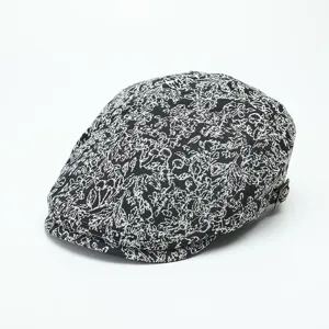 Detailed view of black and white floral jacquard ivy cap with a side metal buckle.