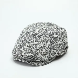 Detailed view of the vintage black and white floral patterned flat cap, ivy beret texture.