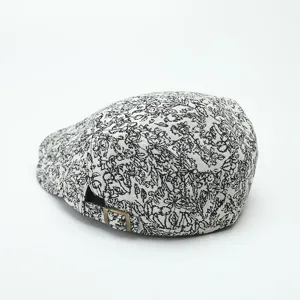 Black and white floral print flat cap with adjustable metal buckle back, detailed view.