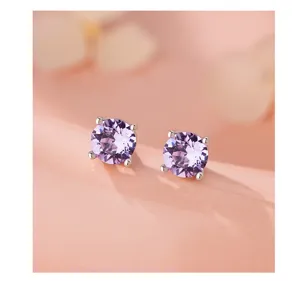 Belles boucles d'oreilles en argent avec zircone violette, design rond minimaliste et chic.