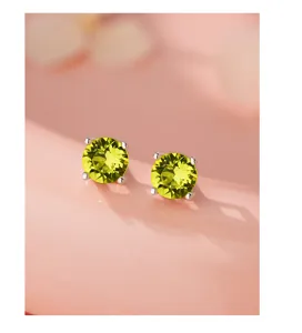 Gros plan détaillé de boucles d'oreilles clous en pierre précieuse ronde étincelante.
