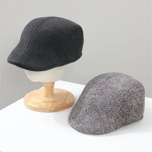 Close-up detail of winter warm herringbone flat cap, classic ivy newsboy hat design for men.