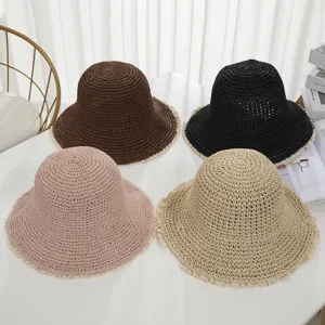 Detail shot of crochet straw bucket hat with lace trim, summer beach sun protection hat.